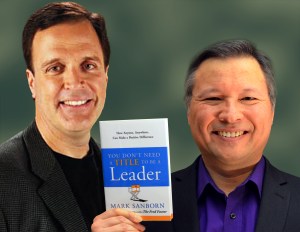 Tom Marcoux holds Mark Sanborn's book 